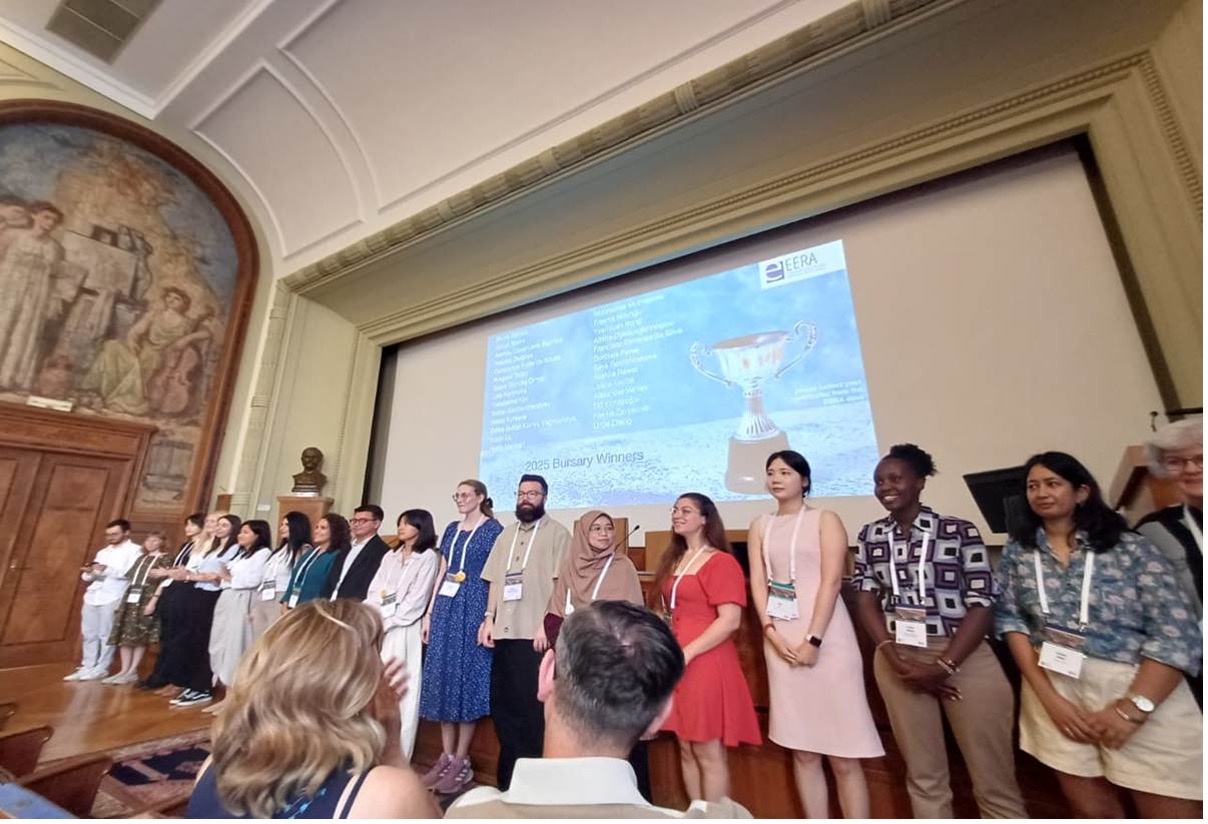A group of ERC bursary winners on stage, being celebrated at the EERA conference 